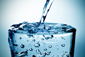 closeup of a refreshing glass of water which is being filled